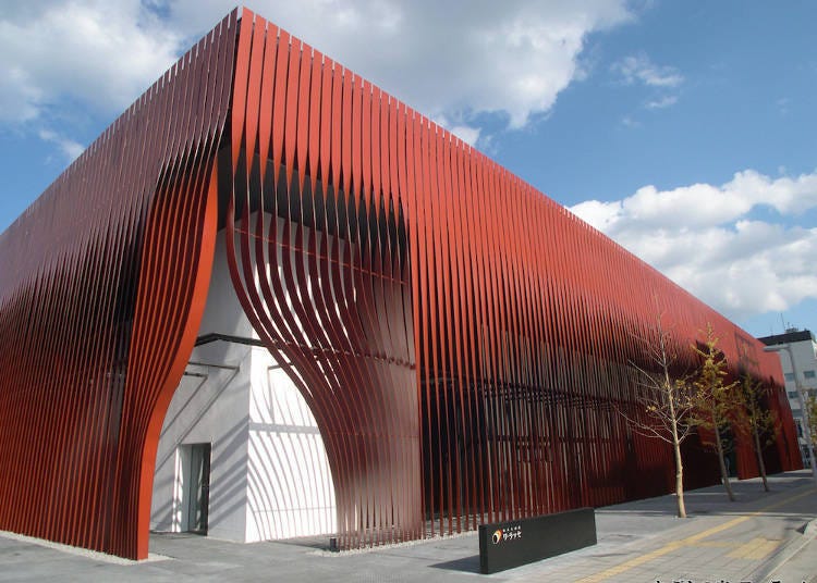 The exterior of Nebuta-Museum WA RASSE is painted in red, a color symbolic of the Nebuta.